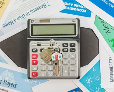 mortgage papers all around a calculator and house keys for homebuyers