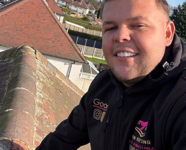 Professional roofing contractor smiling while inspecting residential roof ridge tiles during a maintenance service.