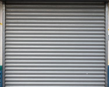 A close-up of various types of window shutters displayed in a workshop.