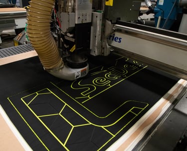 CNC machine cutting custom SeaDek flooring patterns for precise boat deck installation