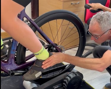 Close-up of a bike fitter checking cleat alignment