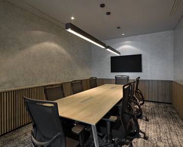 a conference room with a long table and chairs