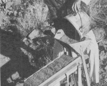 a man in a mining outfit holding mining equipment