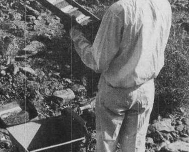 a man in a mining outfit holding mining equipment