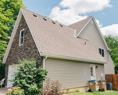 house with a brown shingle roof