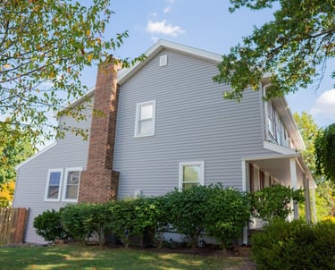house with gray horizontal siding and white windows