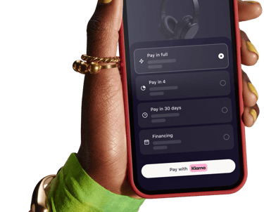 klarna interest free payments a person holding a cell phone with a cell phone in their hand