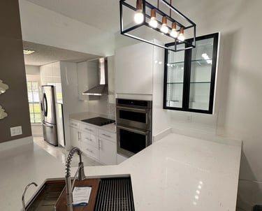 Kitchen remodel with wood accents, large prep island, and under-cabinet lighting by Central Florida 