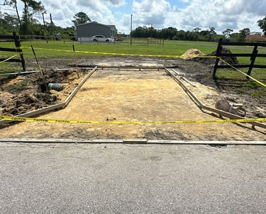Concrete driveway construction in Kissimmee, FL with reinforced foundation and clean edge finishing 