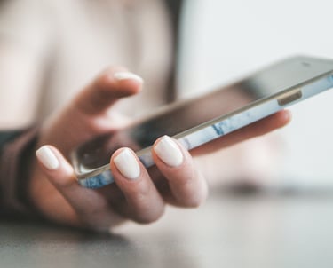 a woman's hand holding a cell phone