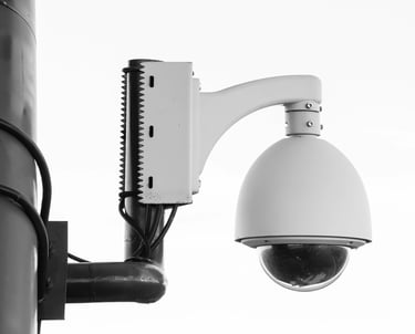 a camera mounted to a pole with a camera attached to it