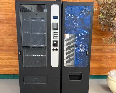 a vending machine with a plant in the background