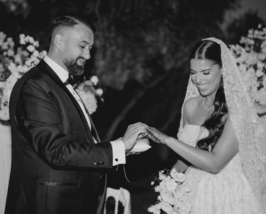 a bride and groom holding hands while they are getting married
