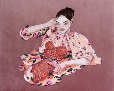 Embroidery of a woman in a pink dress with flower sitting on a chair