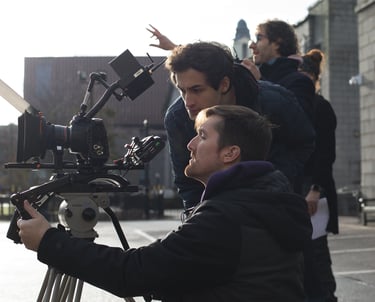 Production services film: a man holding a camera and another camera