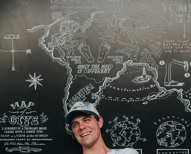 man in front of blackboard happy for receiving leadership coaching