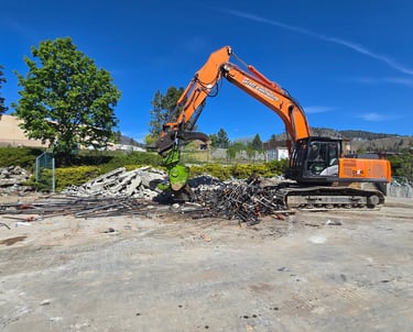 Excavator with a shear attachment cutting scrap metal