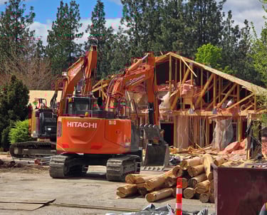 two excavators demolishing a structure