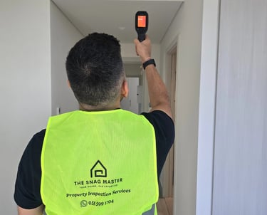 Engineer using thermal camera during ceiling inspection in Abu Dhabi villa