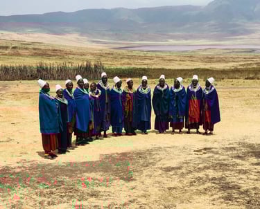 A group of Maasai women standing in semi circle.