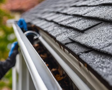 a man in a yellow vest is cleaning the floor