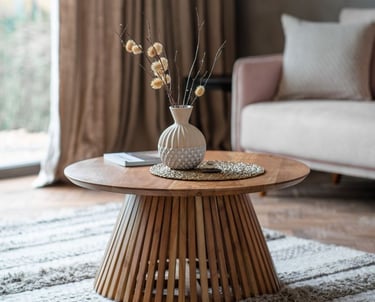 a table with a vase and vase with flowers in it
