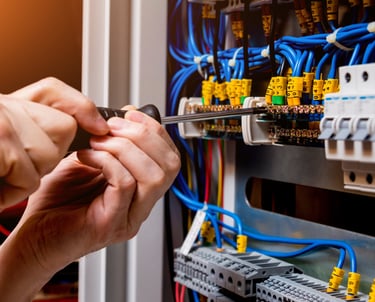 Electrician working on a commercial panel