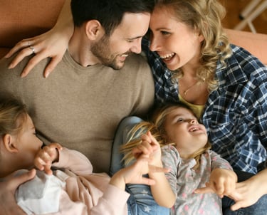 young family on the sofa laughing