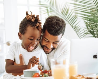 father and child eating at table