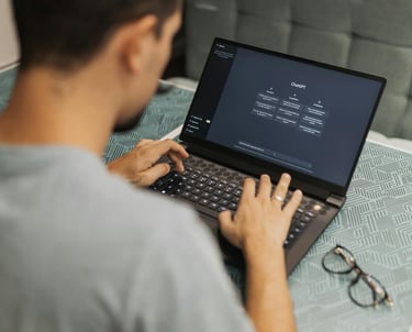 a man sitting on a couch with a laptop computer using chat GPT-4