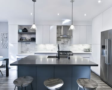 a kitchen with a stainless steel refrigerator and a large island