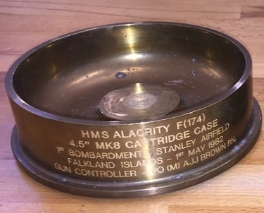 a metal gun shell case from FGalkland Islands engraved
