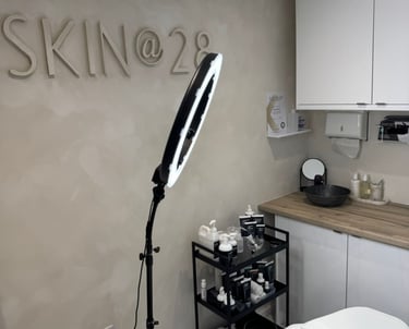 inside of beauty clinic showing clean boutique space and Skin @ 28 sign