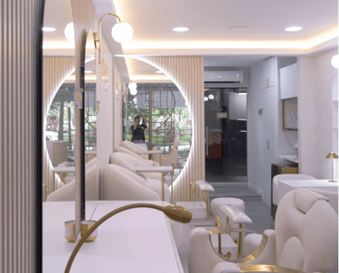 Zona de espera con espejos iluminados y sillones blancos.