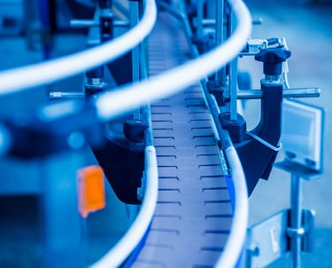 Industrial machinery and workers in a modern manufacturing plant