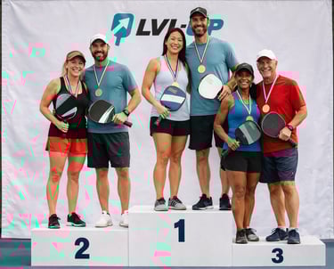 Pickleball podium ceremony with medal winners at a competitive event