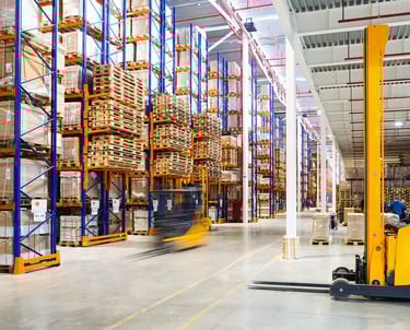 a forklift truck moving through a warehouse
