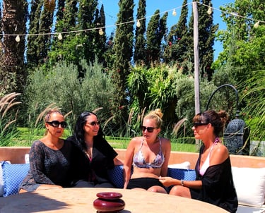A group of women in conversation in the sun