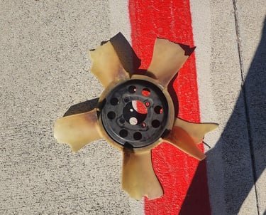 Broken cooling fan on ground