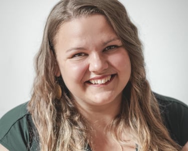 a woman with long blonde hair and earrings and big smile