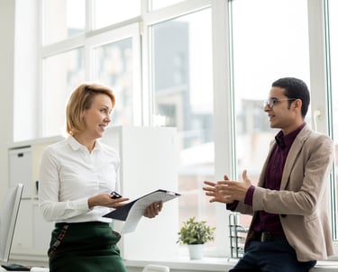 a man and woman in business attire talking to each other