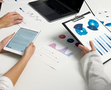 a group of people sitting at a table with papers and papers