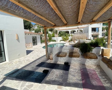 Private yoga studio in Benissa with mats, blocks, and props in outdoor pergola setting by pool