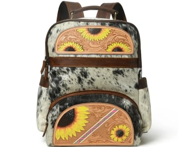 Western cowhide leather backpack featuring hand-tooled floral sunflowers and a black and white fur design.