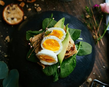 Healthy balanced meal with eggs avocado and greens nutritious food