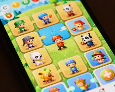 A close-up of a smartphone screen showing a vibrant, colorful puzzle game interface with playful characters.