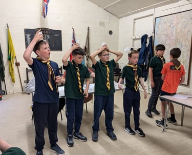 Scouts carrying out games and activities in the hut at Grassendale