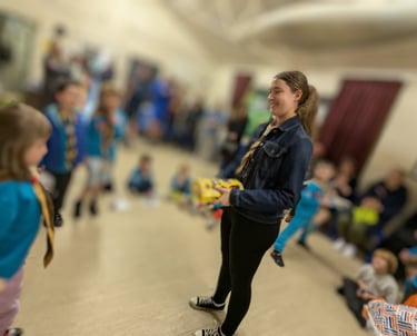 A young leader gets a present at the Scout hut in Cressington