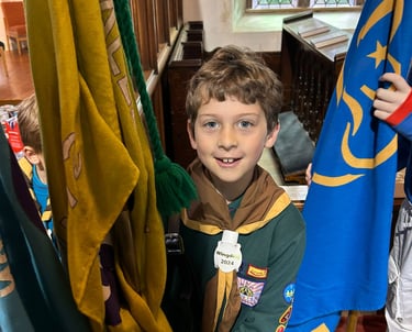 A happy cub waiting to carry a flag in St Mary's Church Allerton