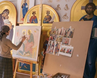 An artist paints a religious icon on an easel inside a studio filled with Byzantine art.